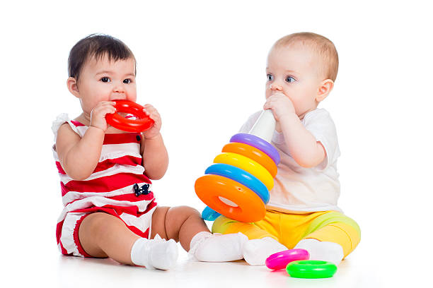 istock babies girls play toy together 178085753