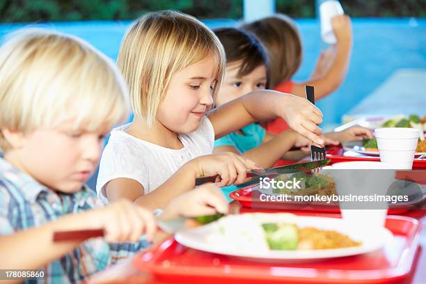 Elementary Pupils Enjoying Healthy Lunch In Cafeteria Stock Photo - Download Image Now