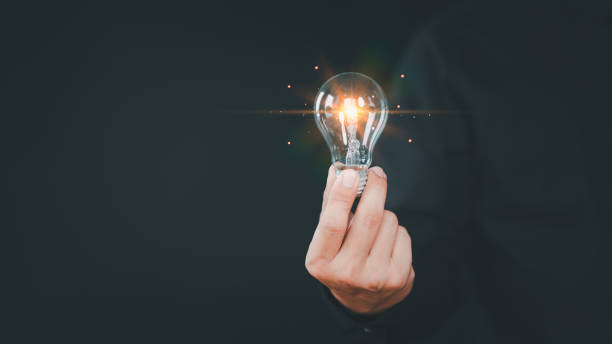 istock Hand holding illuminated light bulb, copyspace. Creative idea, new business plan, motivation, innovation, inspiration. Energy saving light bulb. Concept of new ideas with innovation and creativity. 1780861918