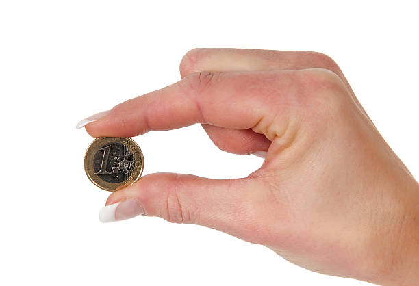 istock one euro coin hold between two fingers 178086973