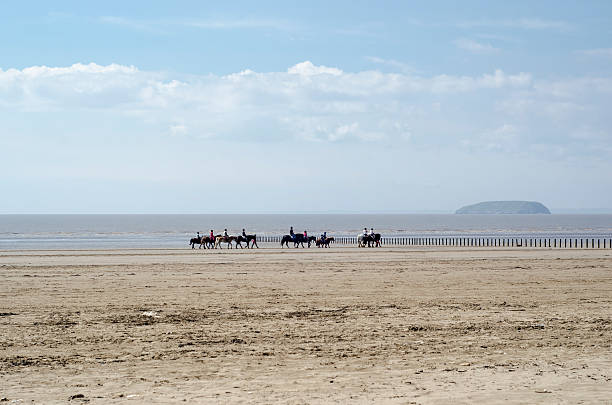 istock Holidaymakers ride horses across Brean beach, England 178087056