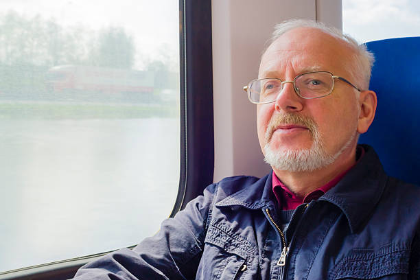 istock Relaxed old man sitting near the window in carriage 178087178