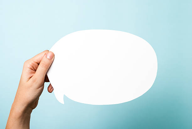 istock Hand holding white blank announce. Converse speech bubble, blue background 178087800