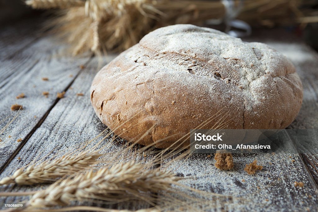 homemade bread and wheat ears homemade bread and wheat ears, closeup Baked Stock Photo