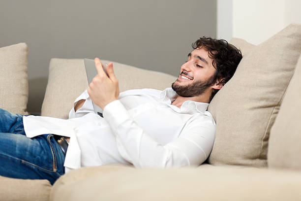 istock Young man relaxing with cellphone 178088197