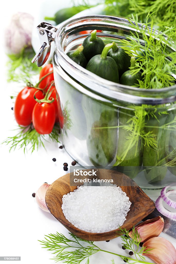 preparing preserves of pickled cucumbers and tomatoes preparing preserves of pickled cucumbers and tomatoes in jars with spices and herbs Autumn Stock Photo