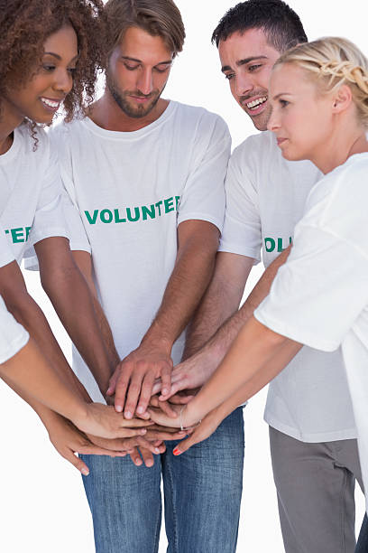 istock Smiling volunteers putting hands together 178088848