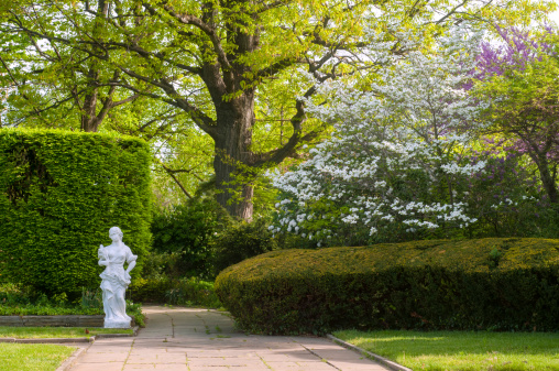 A section of a Cleveland city garden with statuary and flowering trees in spring