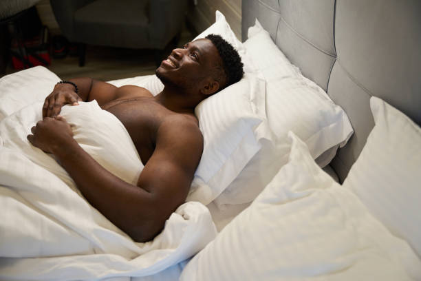 istock Smiling guy with a naked torso enjoys morning relaxation 1780895946