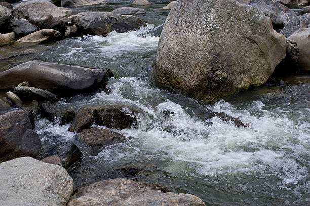 istock Water flowing over and around rocks 178089653