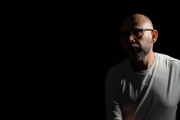 Bald, bearded man wearing casual clothes