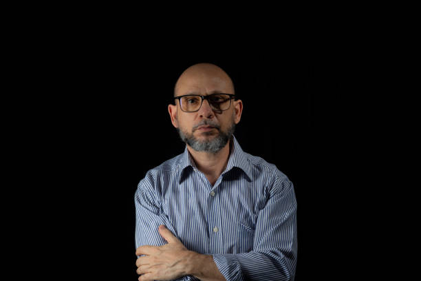 istock Serious, bald and bearded man looking at the camera 1780898702