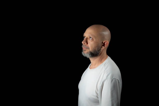 Bald, bearded man wearing casual clothes