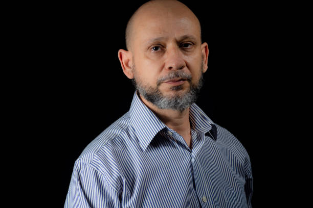 istock Serious, bald and bearded man looking at the camera 1780898729