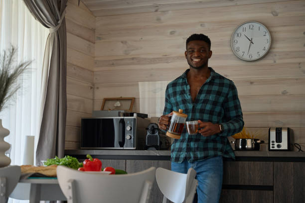 istock African American man sits in a cozy kitchen 1780900901