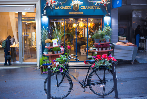 Paris, France: A flower shop with a flower-bedecked bike outside on Rue des Martyrs, 9th arrondissement.