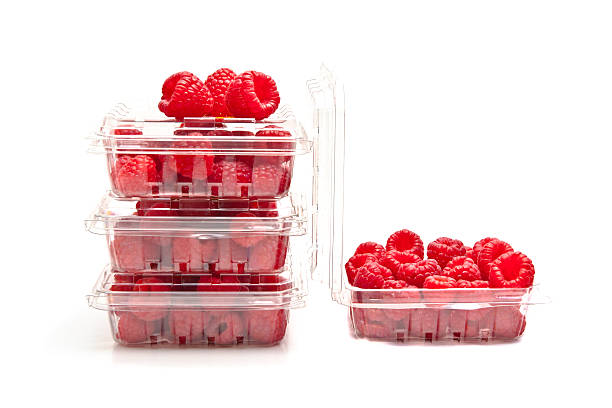 Red raspberries in plastic fruit containers stock photo