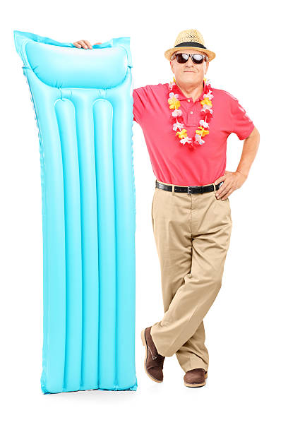 istock Mature man on vacation holding a swimming mattress 178091611