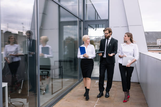 istock Three happy business people are walking outdoors together with a 1780917795