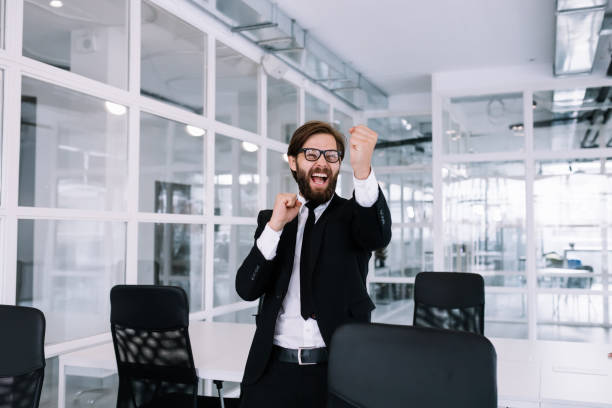 istock Young handsome man with a beard working in the office is dancing 1780917804