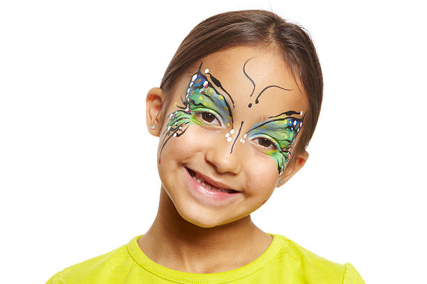 Young girl with face painting butterfly smiling on white background