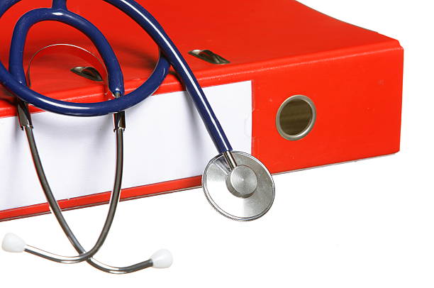 istock Blue stethoscope and red binder isolated on white 178092457
