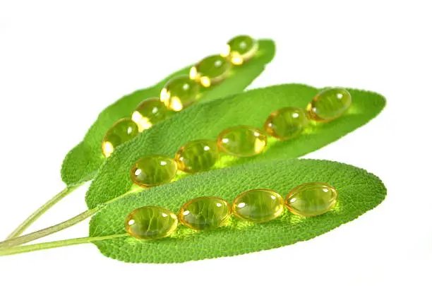 fish-oil capsules on sage leaves
