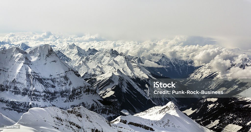 Over the mountain peaks of Rocky Mountains, Banff, Alberta, Canada "Aerial photo shoot from a single-engine, high-wing, Cessna C210. Kootenay Plains, Banff, Alberta, Canada, April 2010." Above Stock Photo