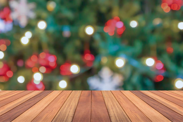 istock Empty wood table top with blur Christmas tree with bokeh light background 1780934796