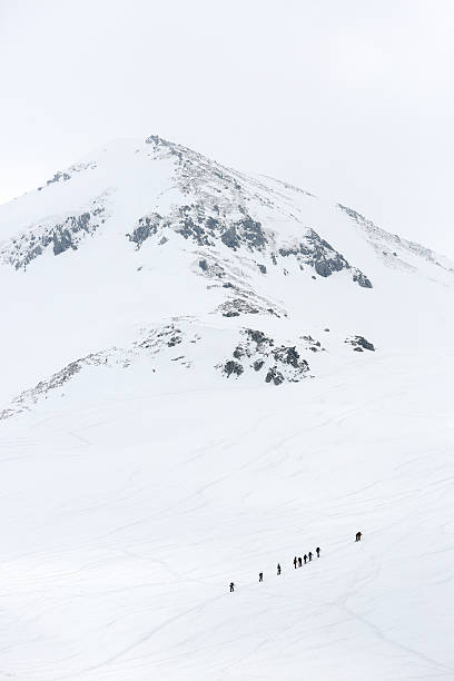 istock Group of hikers climbing a snow mountain 178093535