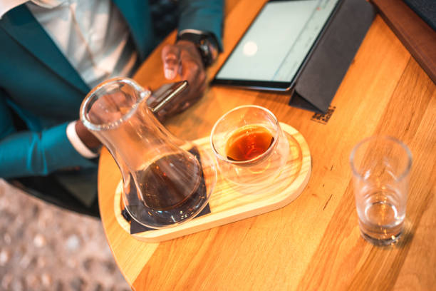 Close up on a table in a cafe. Black businessman working using digital tablet and smarthphone.