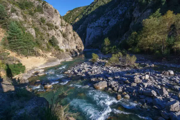 Photo of River Ara in the Pyrenees mountains seen from pedestrian bridge of ghost town of Janovas, Aragon, Huesca, Spain