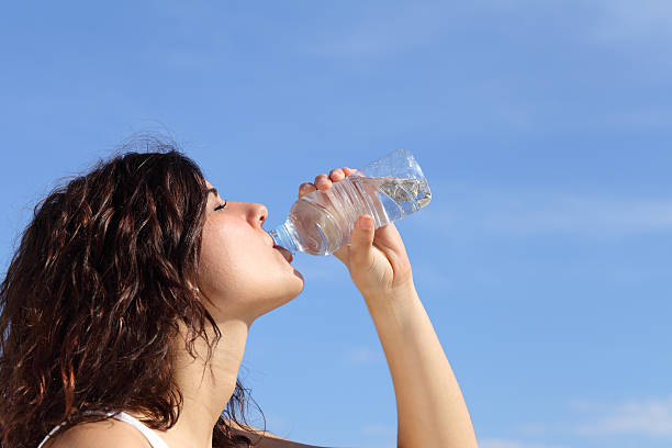 istock Profile of a woman drinking water from plastic bottle 178093863