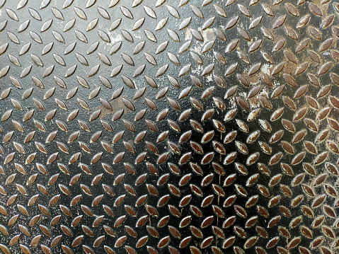 Silver and black painted metallic plate anti slip surface. Metal diamond plate texture.