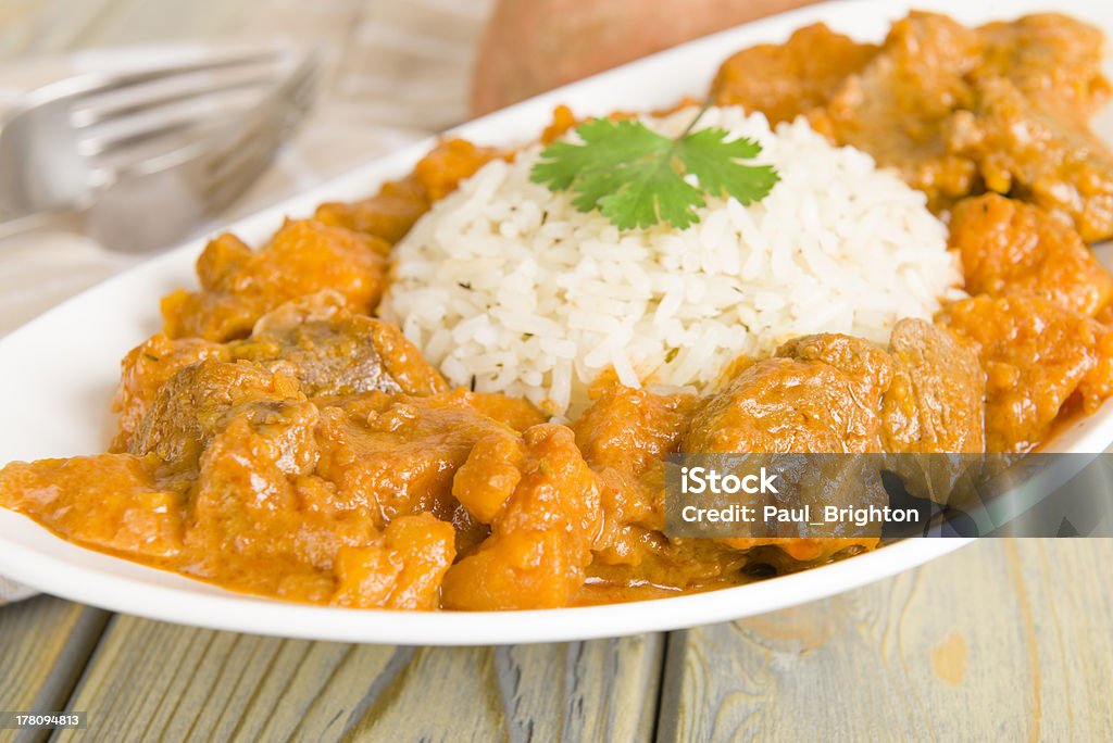 Caribbean Lamb and Sweet Potato Curry Lamb and sweet potato peanut stew served with white rice. Caribbean and West African traditional dish. Peanut - Food Stock Photo