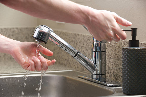 istock Hands reach for soap at the kitchen sink 178095143
