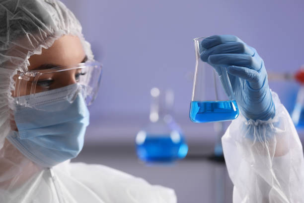 istock Scientist holding flask with light blue liquid in laboratory, closeup 1780952164