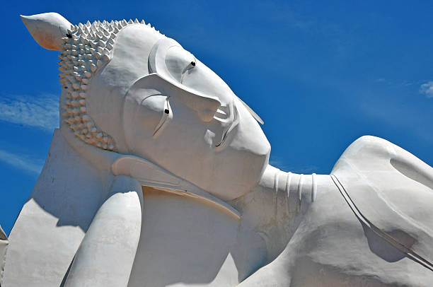 istock Giant reclining buddha over blue sky 178095246