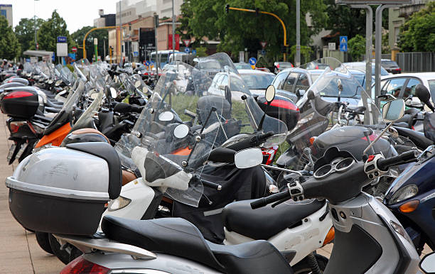 istock many scooters and motorcycles parked in road car park 178096013