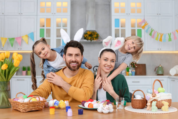 istock Portrait of happy family and Easter eggs at table in kitchen 1780965258