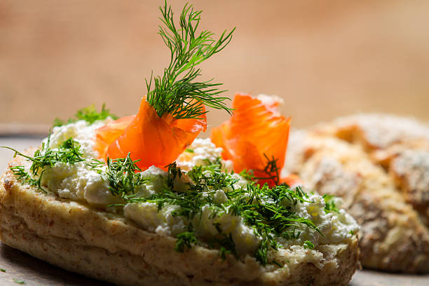 Closeup of sandwich with cottage cheese, salmon and dill