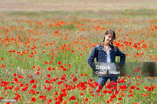 Girl With Poppies Posing Happily Stock Photo - Download Image Now - Activity, Adult, Adults Only