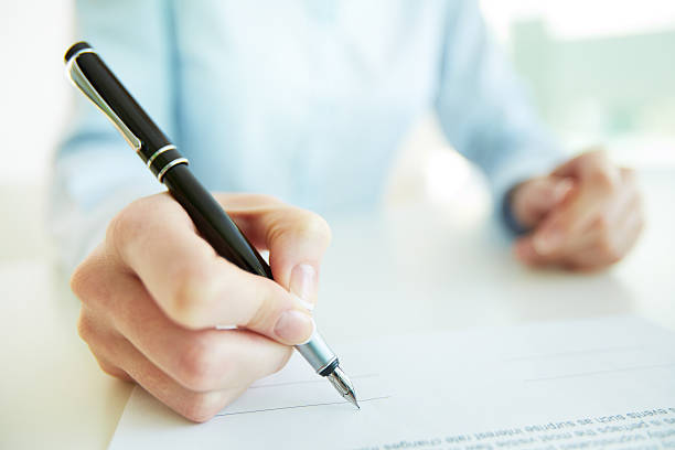 istock A person about to add their signature 178098890