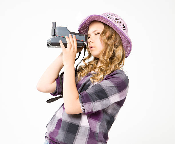 Teenage girl doing photo polaroid camera stock photo