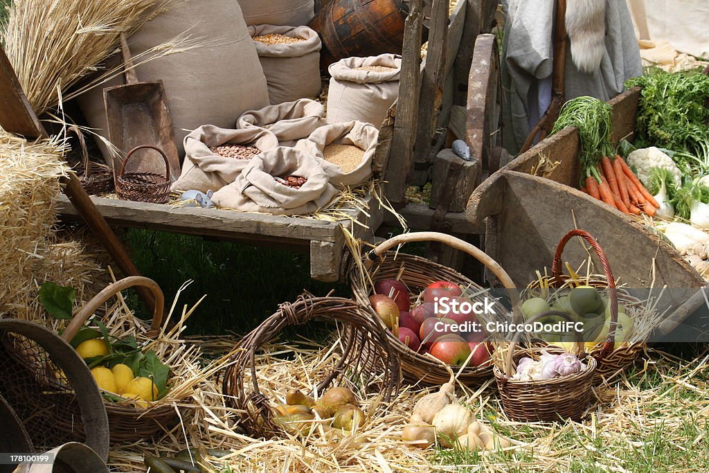 baskets with seasonal fruit and vegetables cart and baskets with seasonal fruit and vegetables for sale at the old market Apple - Fruit Stock Photo