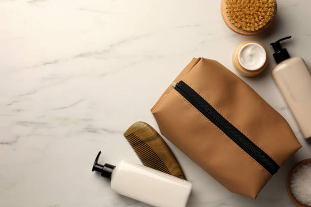 istock Preparation for spa. Compact toiletry bag and different cosmetic products on white marble table, flat lay with space for text 1781002848
