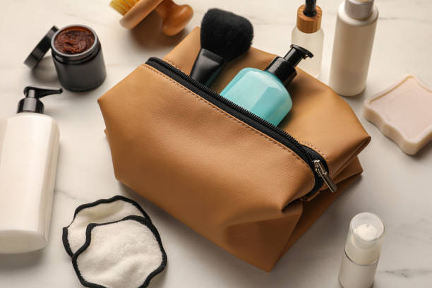 istock Preparation for spa. Compact toiletry bag and different cosmetic products on white marble table 1781003394