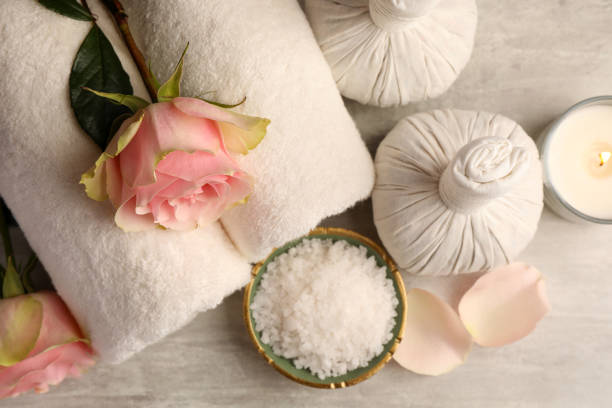 istock Flat lay composition with spa products, roses and burning candle on grey textured table 1781005125