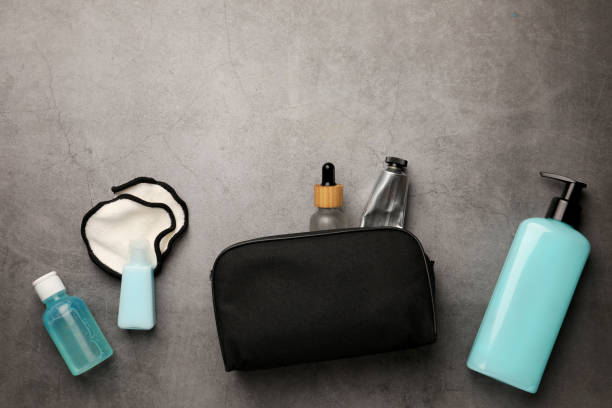 istock Preparation for spa. Compact toiletry bag with different cosmetic products on grey textured background, flat lay. Space for text 1781005178
