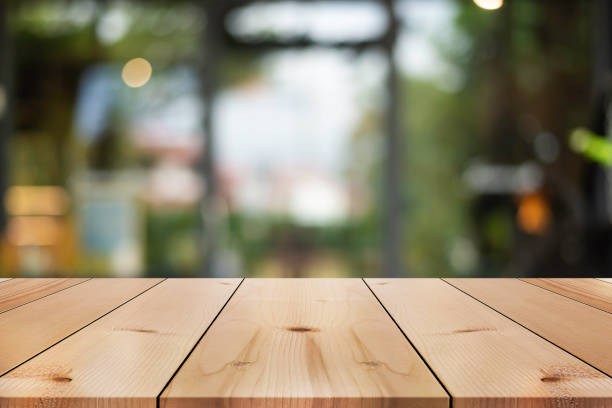 istock Empty wooden table top with lights bokeh on blur restaurant background. 1781005770
